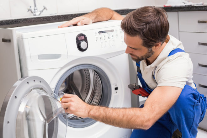man fixing washing machine