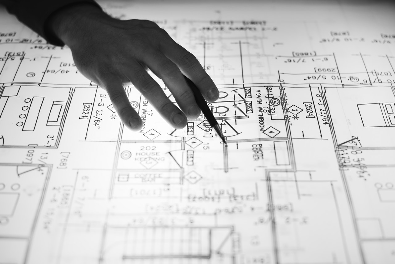 a person pointing at a home sketch